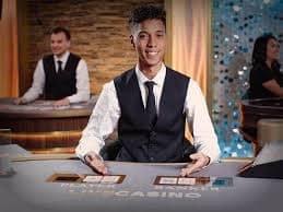 Live Sic Bo table with three dice under transparent dome